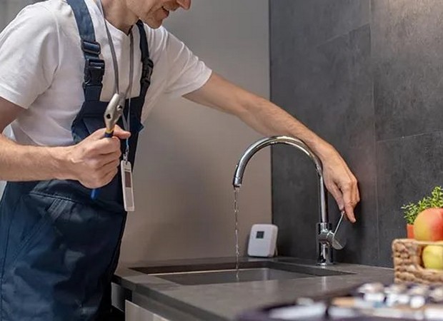 Professional plumber fixing a clogged drain during an emergency call in Las Vegas